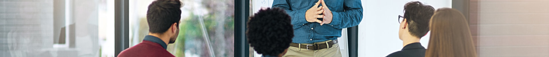 a group of employees listening to a counselor